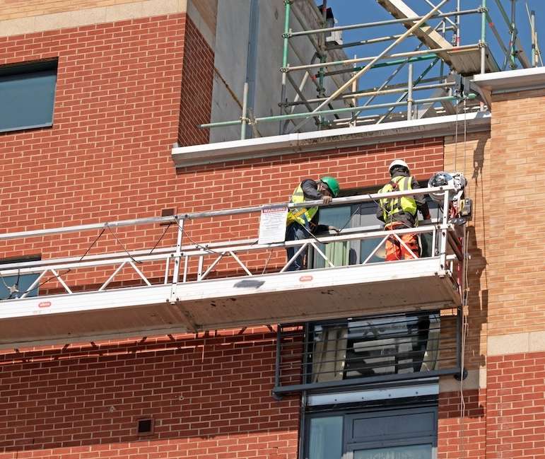 わかりやすくいうと、建物の外壁に大型の張り出し材をボルトで固定し、そこにベランダのような足場を設置するイメージです。